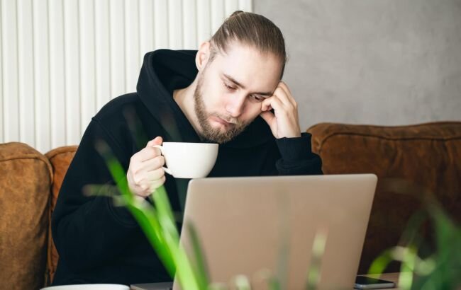 tired_young_man_working_on_a_laptop_with_a_cup_of_coffee_650x410.jpg tired_young_man_working_on_a_laptop_with_a_cup_of_coffee_650x410.jpg